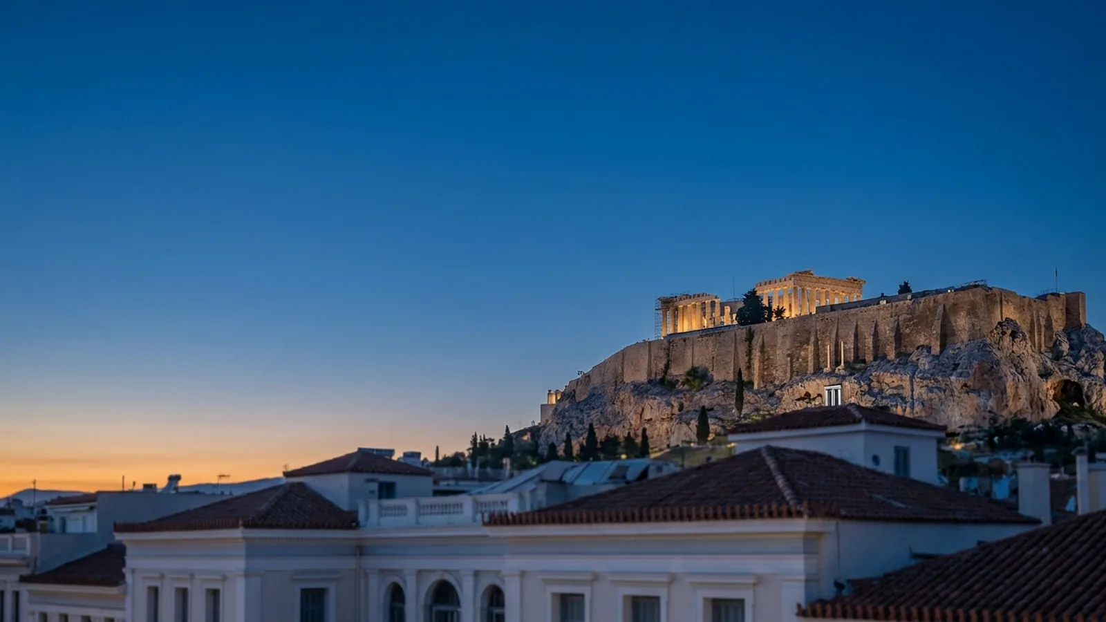 The Acropolis above the rooftops of Athens at blue hour